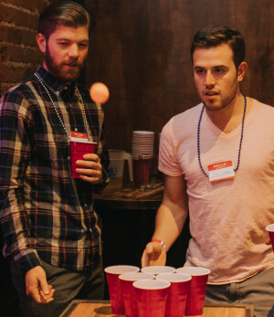 friends playing beer pong